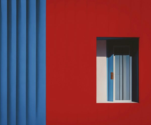 This image shows the outside of a building painted with red and blue paint professionally. This is used in exterior painting section to show the work of exterior painting