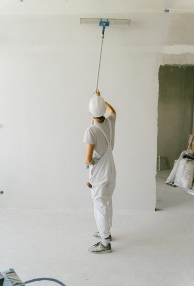 Quality Painting Services in Dubai-main page-man in white painting wall